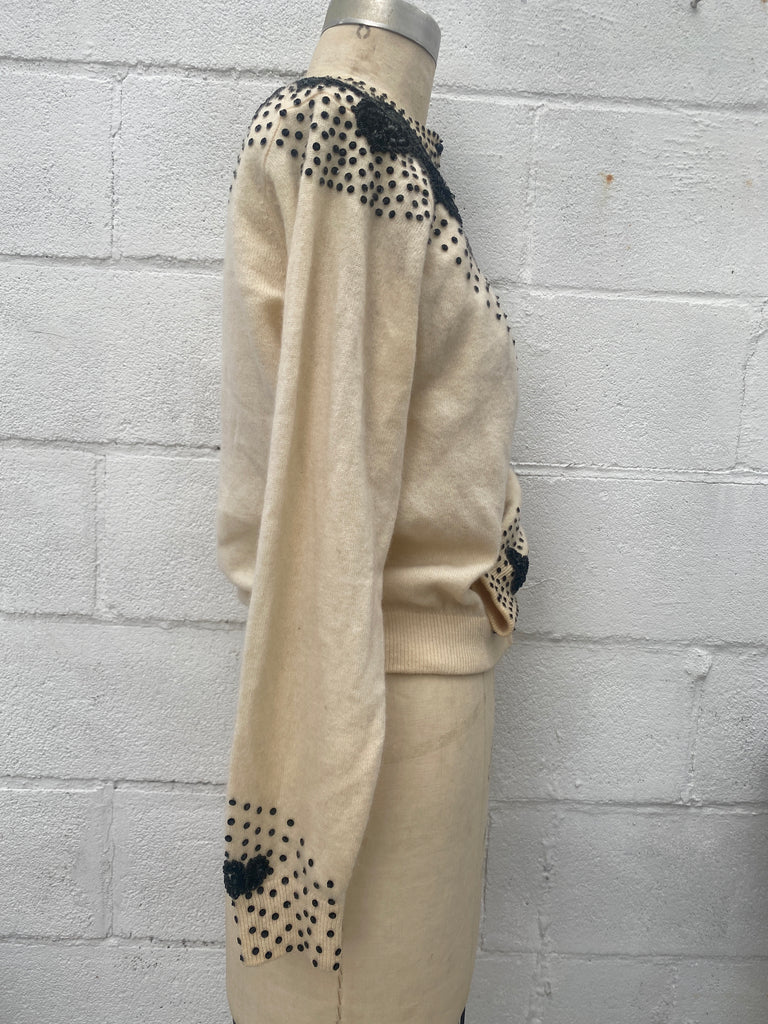 1950s vintage cream color Cashmere button up cardigan sweater with hand beaded black beads,  sequins, and beaded appliqué on the shoulders and wrists.  Size Small / Medium